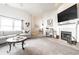 Bright living room featuring a fireplace, large windows, and modern decor at 12210 Doncaster Ct, Fishers, IN 46037