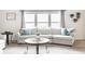 Bright and cozy living room featuring a comfortable sectional sofa, large windows, and neutral decor at 12210 Doncaster Ct, Fishers, IN 46037