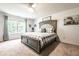 Comfortable main bedroom featuring a cozy bed with a patterned duvet and bright natural light at 12210 Doncaster Ct, Fishers, IN 46037