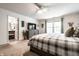 Bright main bedroom featuring a large bed, dresser with TV, and an ensuite bathroom at 12210 Doncaster Ct, Fishers, IN 46037