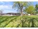Expansive backyard featuring a well-maintained lawn and beautiful mature trees, perfect for outdoor enjoyment at 1243 N Post Rd, Indianapolis, IN 46219