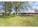 Large backyard with mature trees and a well-kept lawn, offering plenty of space for recreation at 1243 N Post Rd, Indianapolis, IN 46219