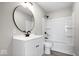 Modern bathroom boasts new vanity, round mirror, and updated shower and tub at 1243 N Post Rd, Indianapolis, IN 46219