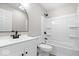 Modern bathroom boasts new vanity, round mirror, and updated shower and tub at 1243 N Post Rd, Indianapolis, IN 46219