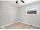 This is a bright bedroom with light gray walls, light wood flooring, and a window at 1243 N Post Rd, Indianapolis, IN 46219