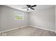 Bedroom features light walls, wood-look floors, and a window offering ample natural light at 1243 N Post Rd, Indianapolis, IN 46219