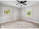 Bedroom features light walls, wood-look floors, and windows offering ample natural light at 1243 N Post Rd, Indianapolis, IN 46219