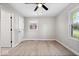 Light and airy bedroom features wood-look floors and a window at 1243 N Post Rd, Indianapolis, IN 46219