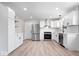Modern kitchen features white cabinets, stainless steel appliances, new vinyl floors, and marble countertops at 1243 N Post Rd, Indianapolis, IN 46219