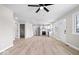 Open concept of the living room and kitchen with natural light, white walls, and new vinyl floors at 1243 N Post Rd, Indianapolis, IN 46219