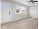 Bright living room with light-colored walls, new vinyl floors, ceiling fan, and ample natural light at 1243 N Post Rd, Indianapolis, IN 46219