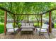 Inviting backyard deck area with outdoor seating and a pergola, perfect for relaxing and entertaining at 12577 Pointer Pl, Fishers, IN 46038