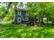 Backyard with lush lawn, swing set, grill, pergola with patio furniture, and mature trees at 12577 Pointer Pl, Fishers, IN 46038