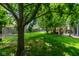 Expansive backyard featuring lush green grass, mature trees, hammock, and a charming pergola with outdoor seating at 12577 Pointer Pl, Fishers, IN 46038