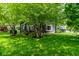 Beautiful backyard showcasing a cozy deck area, mature trees, and lush greenery, creating a private retreat at 12577 Pointer Pl, Fishers, IN 46038