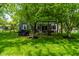 Serene backyard with mature trees, a pergola, and a well-maintained lawn, providing a peaceful outdoor space at 12577 Pointer Pl, Fishers, IN 46038