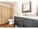 Bathroom features dark vanity with marble top, bronze hardware and faucets, and a shower with curtain at 12577 Pointer Pl, Fishers, IN 46038