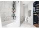 Luxurious bathroom showcasing marble tile, a shower with shelving, and a separate toilet area for added privacy at 12577 Pointer Pl, Fishers, IN 46038