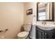 Half bath features a dark vanity, oval sink, chrome hardware and fixtures, and a low-flow toilet at 12577 Pointer Pl, Fishers, IN 46038