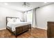 Bright bedroom features a wooden frame bed, white linens, wood floors and a window with natural light at 12577 Pointer Pl, Fishers, IN 46038