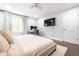 Comfortable bedroom with a desk, TV, and plush king bed, offering a relaxing space for rest and productivity at 12577 Pointer Pl, Fishers, IN 46038