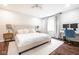 Bright and spacious bedroom featuring a large bed, modern decor, and a dedicated workspace for added convenience at 12577 Pointer Pl, Fishers, IN 46038