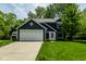 Charming two-story home featuring navy siding, white trim, an attached two-car garage, and a well-manicured lawn at 12577 Pointer Pl, Fishers, IN 46038
