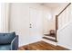 Foyer showcasing hardwood floors, a staircase, and a view into the adjoining rooms at 12577 Pointer Pl, Fishers, IN 46038