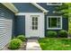 Close-up of the home's front entry showing a white door with glass panels and well-maintained landscaping at 12577 Pointer Pl, Fishers, IN 46038