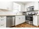 Beautiful kitchen with stainless steel appliances, white cabinets, and plenty of natural light at 12577 Pointer Pl, Fishers, IN 46038