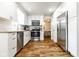 Stainless steel appliances and white cabinets brighten this lovely kitchen with hardwood floors at 12577 Pointer Pl, Fishers, IN 46038