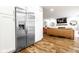 Open concept kitchen with stainless steel refrigerator leading into living area at 12577 Pointer Pl, Fishers, IN 46038