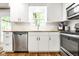 Modern kitchen with stainless steel appliances, white cabinets, and window over the sink at 12577 Pointer Pl, Fishers, IN 46038