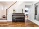 Entryway featuring a vintage piano, hardwood floors, and views into adjacent rooms at 12577 Pointer Pl, Fishers, IN 46038