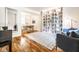 Bright living room featuring hardwood floors, a large area rug, and custom built-in bookshelves at 12577 Pointer Pl, Fishers, IN 46038