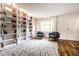 Bright living room featuring hardwood floors, a large area rug, and custom built-in bookshelves at 12577 Pointer Pl, Fishers, IN 46038