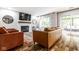 Cozy living room showcasing a fireplace, wood floors, and a sliding door to an outdoor space at 12577 Pointer Pl, Fishers, IN 46038