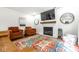 Comfortable living room with fireplace, rustic mantel, and warm tones is ready for move in at 12577 Pointer Pl, Fishers, IN 46038