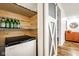 Convenient pantry with shelving for storage, a mini-fridge, and a stylish barn door for easy access at 12577 Pointer Pl, Fishers, IN 46038