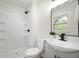 Modern bathroom featuring a walk-in shower, white vanity and a black framed mirror at 1295 Rolling Ridge Dr, Noblesville, IN 46060