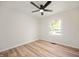 Bright bedroom features a ceiling fan, hardwood flooring, and a window letting in natural light at 1295 Rolling Ridge Dr, Noblesville, IN 46060
