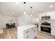 Modern kitchen with stainless appliances, white cabinets, an island and a dining area at 1295 Rolling Ridge Dr, Noblesville, IN 46060