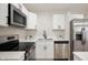 Well-equipped kitchen with stainless steel appliances, white cabinetry and quartz countertops at 1295 Rolling Ridge Dr, Noblesville, IN 46060