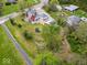 Aerial view of the property showcasing the home, surrounding yard, and detached garage at 1394 N Michigan Rd, Shelbyville, IN 46176