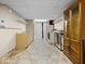Unfinished basement area with a sink, cabinets, and appliances, offering potential for customization at 1394 N Michigan Rd, Shelbyville, IN 46176