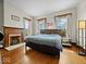 Spacious bedroom features hardwood floors, a fireplace, and natural light at 1394 N Michigan Rd, Shelbyville, IN 46176