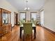 Formal dining room with hardwood floors, large windows, and elegant green upholstered chairs around a spacious table at 1394 N Michigan Rd, Shelbyville, IN 46176