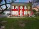 Charming red two-story home with white columns and shutters, exuding classic curb appeal at 1394 N Michigan Rd, Shelbyville, IN 46176