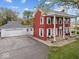 Exterior view showing home's red brick, white columns, and attached garage, blending style and convenience at 1394 N Michigan Rd, Shelbyville, IN 46176