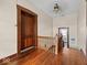 Hallway with hardwood floors, classic trim, and vintage doors at 1394 N Michigan Rd, Shelbyville, IN 46176